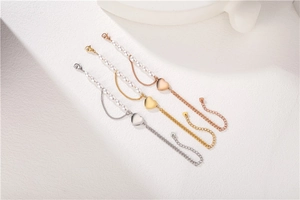 Close-up of pearl heart bracelets in silver, gold and rose gold finishes