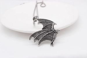 Detailed view of Gothic bat wing pendant showing intricate skeletal textures and vintage finish