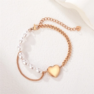 Elegant rose gold heart charm bracelet featuring white pearls and minimalist metal chain links