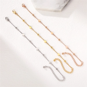 Three minimalist heart charm bracelets in silver, gold, and rose gold with lobster clasp