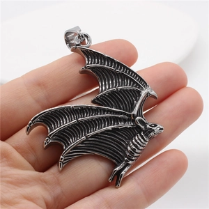 Gothic bat wing pendant necklace in vintage silver steel shown on a display stand