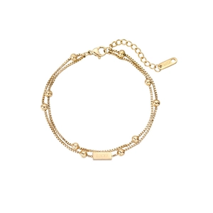 Detail of double-layer golden bracelet with LUCKY engraving and 18KGP tag