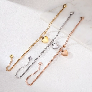 Bracciale con ciondolo a cuore in oro, argento e oro rosa con ciondolo a faccina