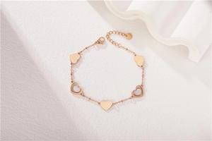 Detail of rose gold heart bracelet with mother of pearl inlays and lobster clasp