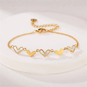 Golden heart charm bracelet with mother of pearl inlays and adjustable chain links