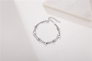 Detail of double-layer silver star bracelet showing S925 engraving and lobster clasp