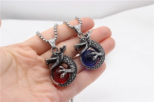 Detail of retro dragon pendants with red and blue beads on stainless steel chains