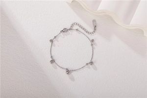 Detailed close-up of a silver beaded chain bracelet with lobster clasp and extension