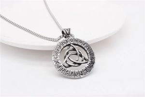 Close-up of Viking Triquetra pendant with Elder Futhark runes on a steel chain necklace