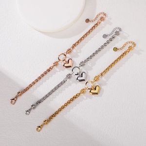 Three Cuban chain bracelets with polished heart pendants in gold, silver, and rose gold