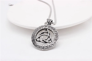 Macro shot of Viking runes pendant with Celtic Triquetra knot on stainless steel wheat chain