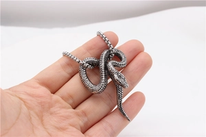 Close-up of retro silver snake pendant showing detailed scales and a sturdy box chain
