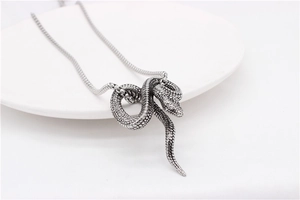 Macro shot of retro silver snake pendant showing detailed scale texture and round snake chain