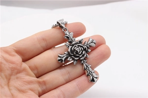 Close-up of gothic rose cross pendant in vintage silver finish with intricate relief