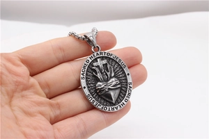 Macro shot of the Sacred Heart of Jesus relief pendant with antique silver finish detail