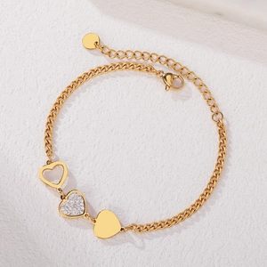 Minimalist gold bracelet featuring hollow, zircon-encrusted, and polished heart pendants