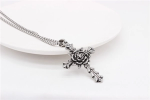 Detailed macro view of vintage gothic rose cross pendant with intricate floral relief