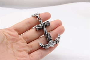 Detailed view of a vintage silver anchor pendant with rope details and nautical styling