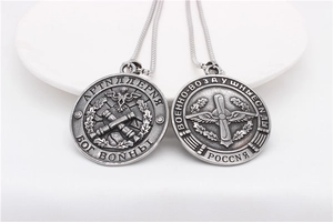 Detailed macro of vintage silver steel pendants with Russian military eagle and wing motifs