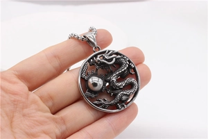 Détail macro du pendentif dragon rétro montrant les écailles et la perle du dragon poli