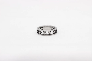 Detailed macro view of the hollow pentagram star patterns on the silver steel ring band