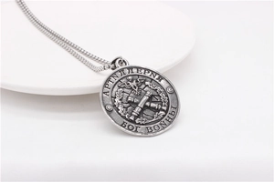 Close-up of retro silver military medallion with Russian double-headed eagle and cannon