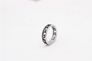 Detailed view of retro stainless steel ring with embossed stars and oxidized black finish