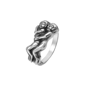 Detailed macro shot of vintage oxidized silver ring with artistic hug sculpture design