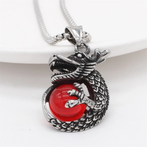 Vintage stainless steel dragon pendant necklace with a red bead in a retro punk style