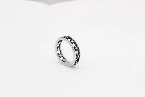 Detailed view of silver titanium steel ring featuring continuous hollow star patterns