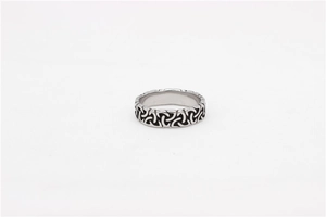 Close-up of vintage Viking Celtic knot patterns on a stainless steel men's ring