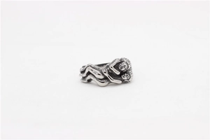 Macro shot of retro hug ring in vintage silver finish with artistic carved figure details