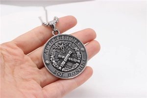 Detailed close-up of a vintage Russian military eagle and cannon embossed steel pendant