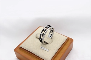 Detail of hollow star pattern and black enamel inlay on vintage titanium steel ring