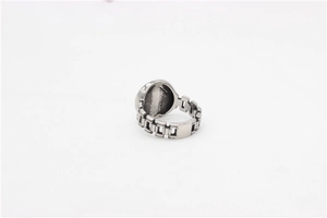Macro detail of vintage silver stainless steel ring with industrial chain band texture