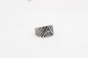 Detailed relief of the All-Seeing Eye and brick wall texture on vintage steel ring