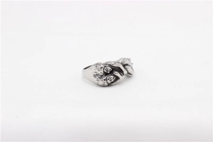 Close-up of retro silver steel ring with detailed human figure relief carving