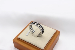 Macro view of vintage hollow star ring with black oxidation on stainless steel band