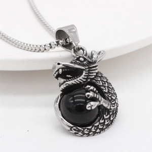 Vintage stainless steel dragon pendant with black bead on a silver box chain