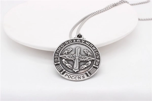 Macro detail of vintage fallen angel cross round pendant necklace with military design