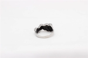 Detailed close-up of a silver hug ring featuring a retro fluid design on white fabric