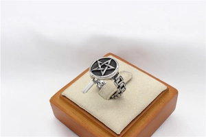 Detailed view of retro stainless steel ring with pentagram shield and chain band