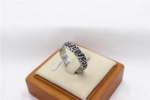 Macro view of vintage Viking Celtic knot patterns on silver-toned steel men's ring