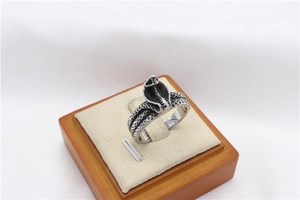 Close-up of vintage cobra snake ring with detailed scales in a jewelry box