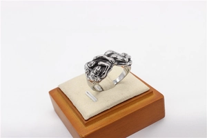 Close-up of vintage embrace relief design on a retro stainless steel couple ring