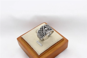 Detailed macro view of retro stainless steel ring with All-Seeing Eye and brick texture