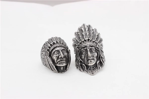 Detailed macro view of vintage Native American chieftain carvings on a silver steel ring