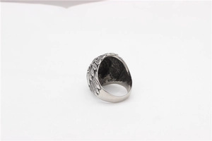 Macro view of vintage silver steel ring with detailed eagle wing feather carvings
