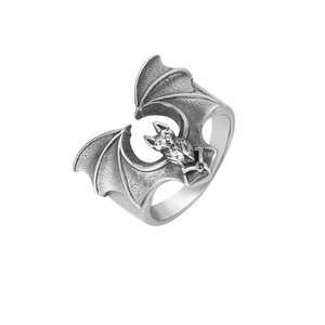 Detailed close-up of a vintage bat ring with engraved textures and oxidized silver finish