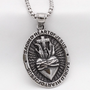 Vintage silver Sacred Heart of Jesus oval pendant necklace with cross and flame detail